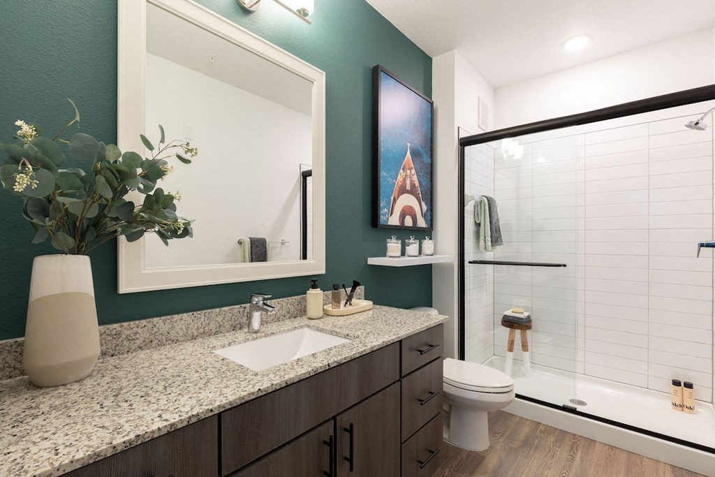 a bathroom with a toilet sink and shower with a glass door in Concorde apartment