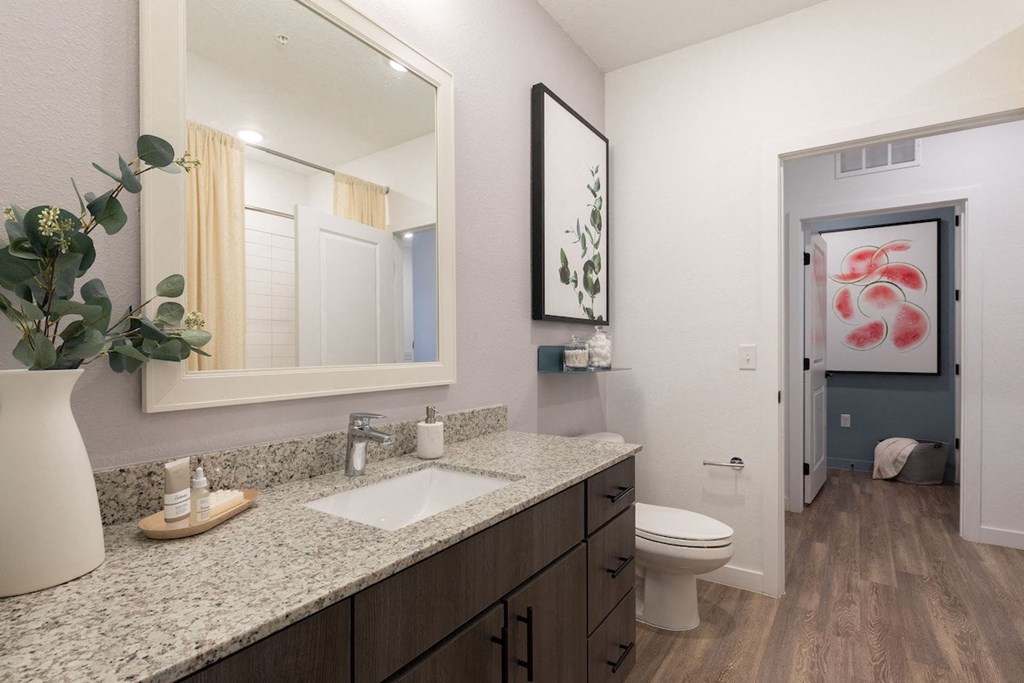 a bathroom with a toilet sink and mirror at Lake Nona Concorde