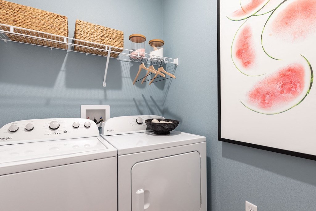 a large in-home laundry room with washer, dryer, and decor at Lake Nona Concorde