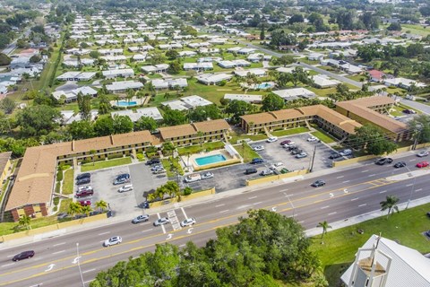 an aerial view of a city with a pool and parking lot