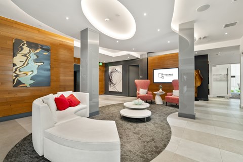A modern living room with a white sofa and a wooden wall.