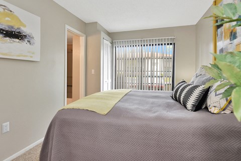 a bedroom with a large bed and a large window