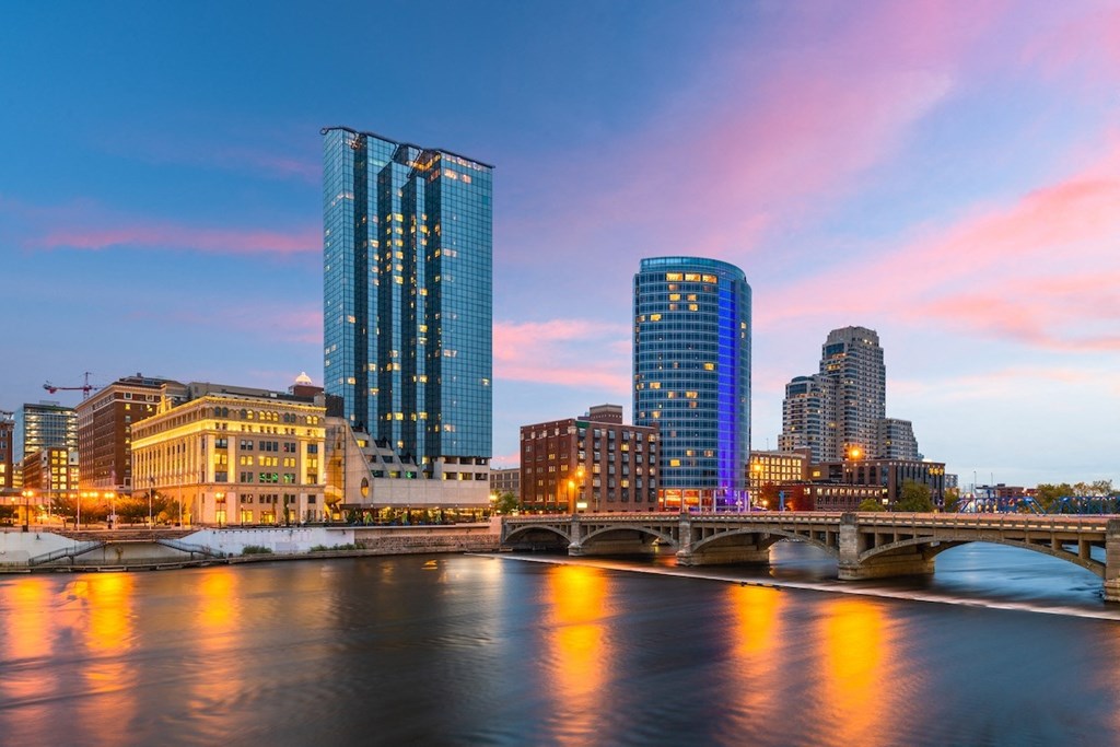 Grand Rapids, Michigan skyline with a river and a bridge at night