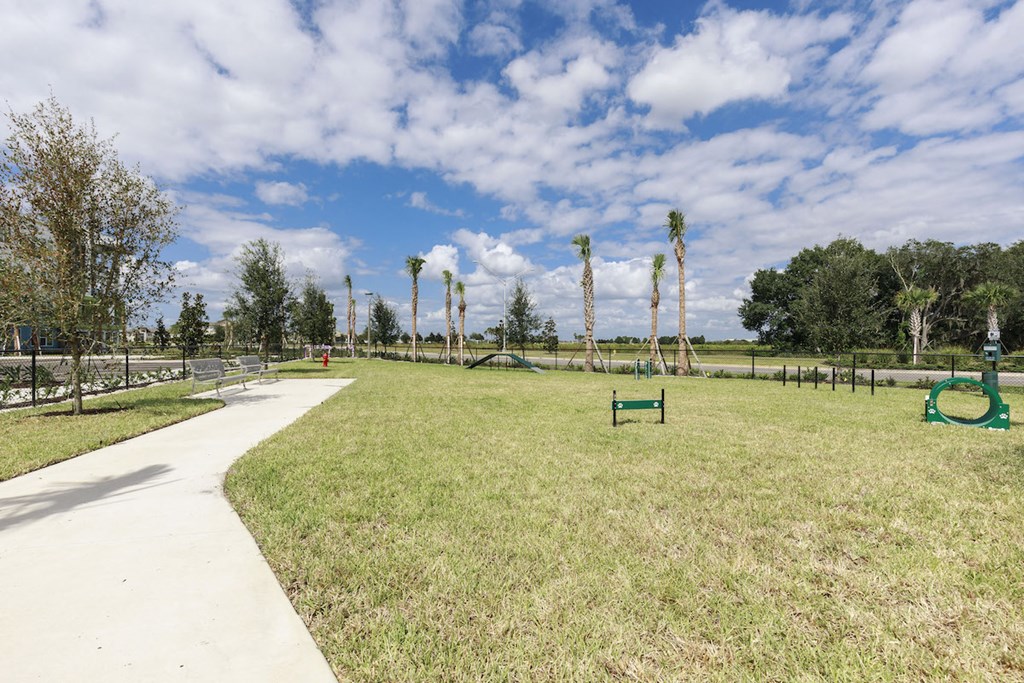 Fenced-in leash-Free Pet Park with agility course at Residences at The Green in Lakewood Ranch, FL