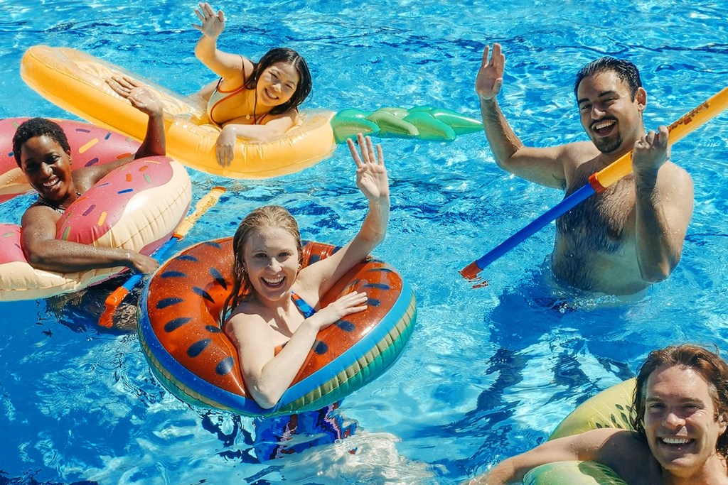 Eastland-Evansville-PG-7 a group of people in a swimming pool in inflatable pool floats