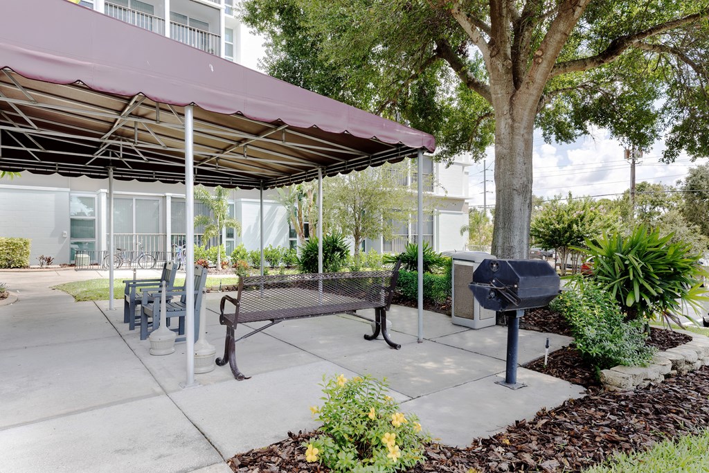 A park area with a bench and a mailbox.