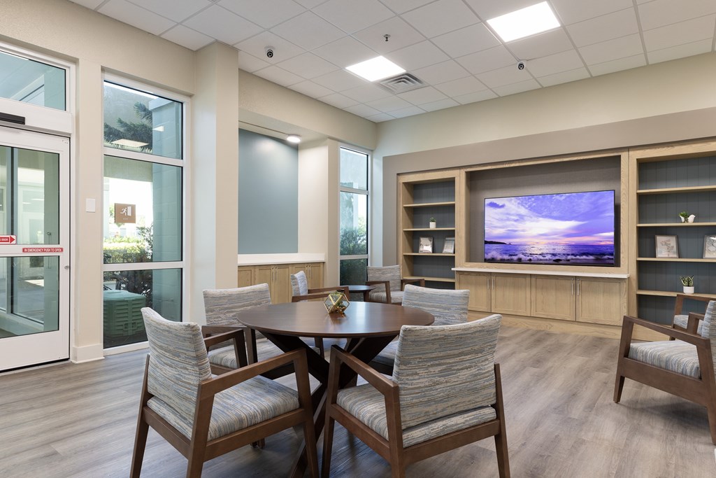 A modern dining room with a wooden table and chairs.