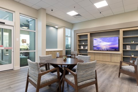 A modern dining room with a wooden table and chairs.