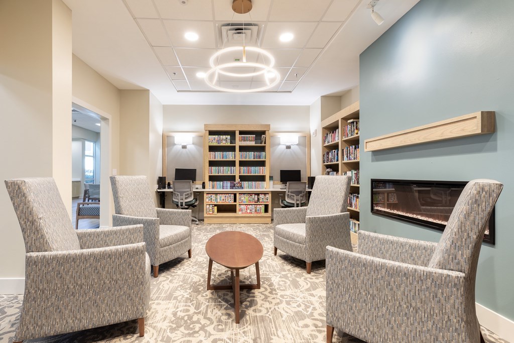 A room with a fireplace and bookshelves.