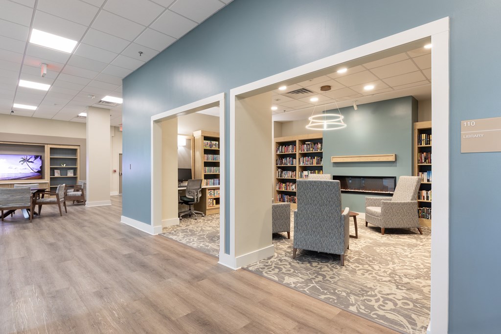 A library with bookshelves and chairs.