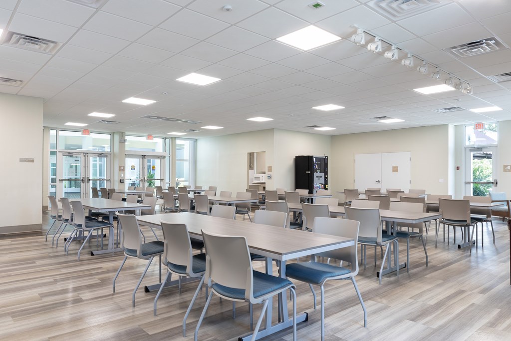 A large room with tables and chairs.