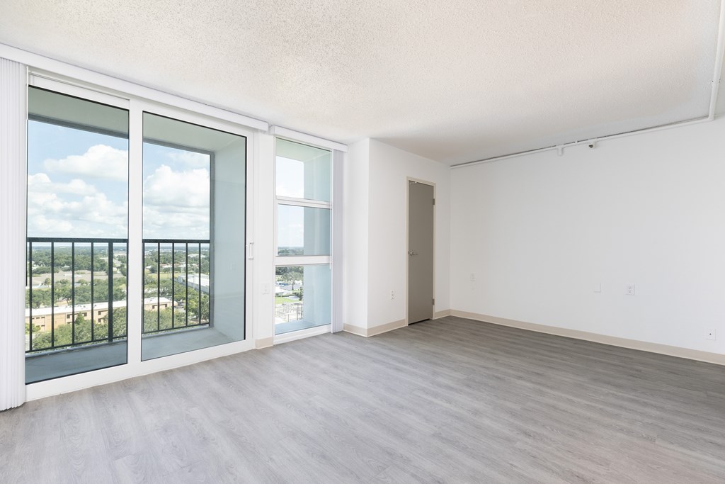 A room with a view of the city through the window.
