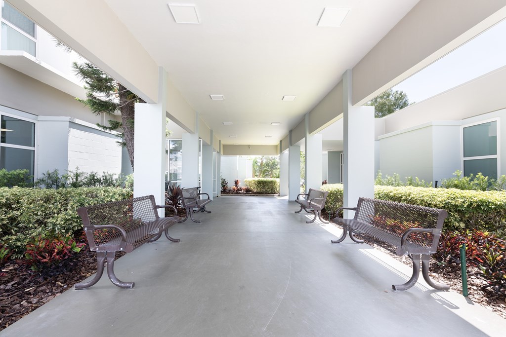 A long hallway with benches on either side.