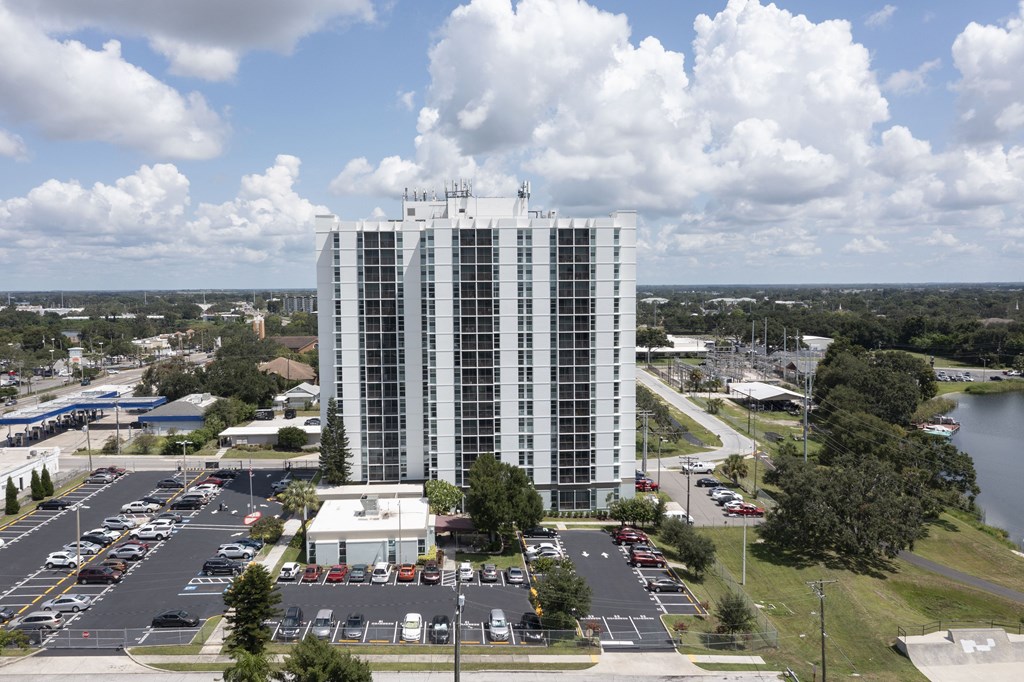 A tall white building with a sign on the top of it.