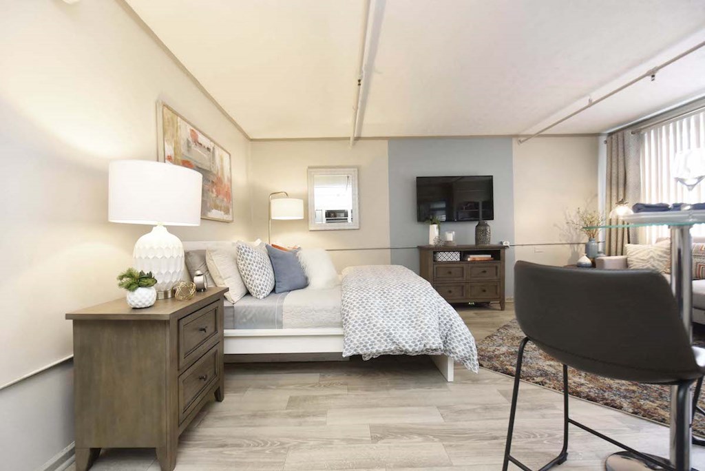 bedroom and living room area with model furnishings and designer paint