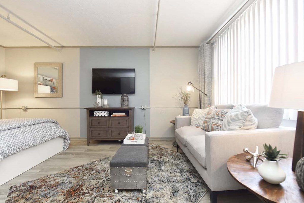 living room area with large window and vertical blinds