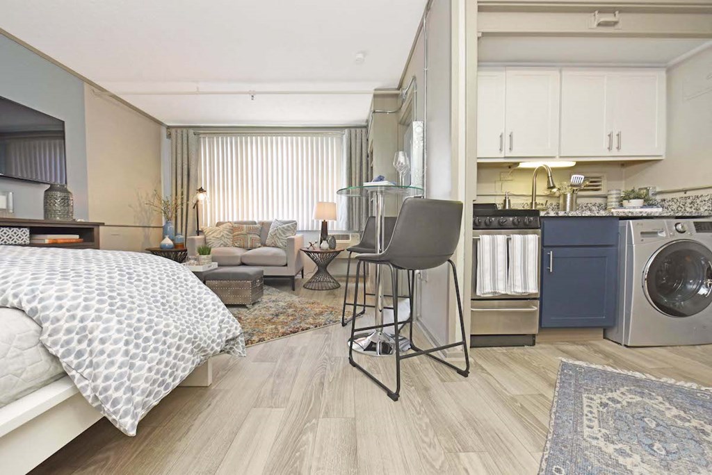 combo washer and dryer in kitchen and wood-style floors throughout