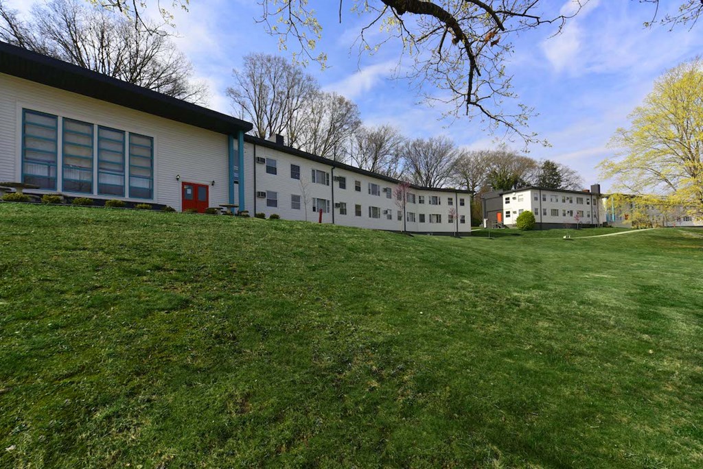 Lush green lawn and mature trees outside of The Flats at Jackson Square