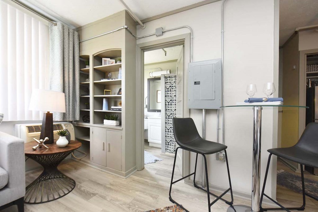 small dining area, built-in shelving, and bathroom entrance