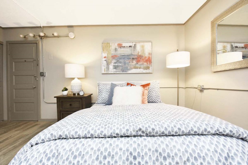 bedroom area with model furnishings and door