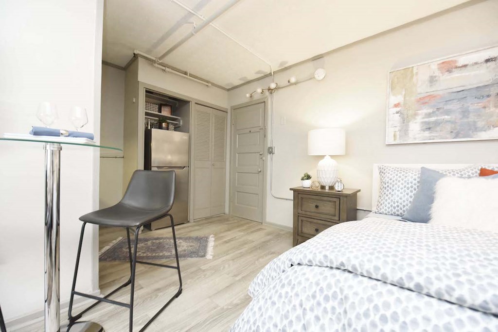bed, small dining area, and kitchen in studio apartment at The Flats at Jackson Square