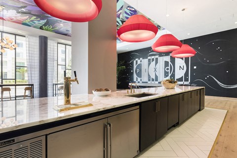 a kitchen with counters and a bunch of red lamps