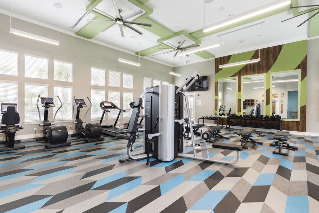 expansive fitness studio with weight tower and cardio machines
