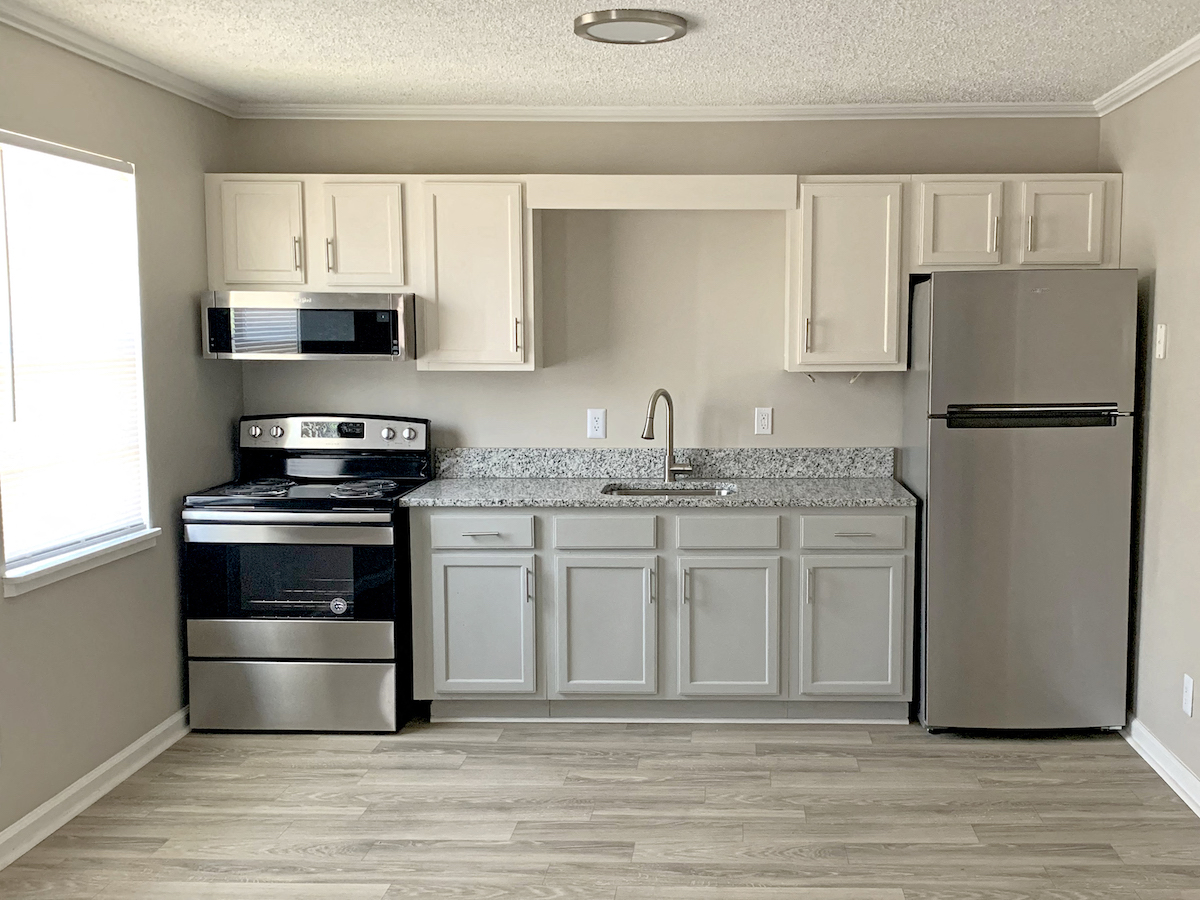a kitchen with stainless steel appliances and white cabinets