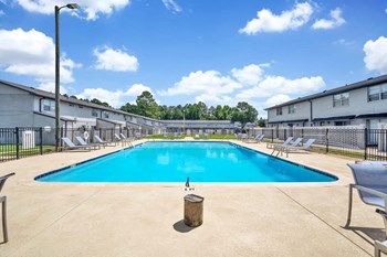 Goshen-Estates-Gallery-9 Swimming pool with large sundeck and lounge chairs at Goshen Estates Apartments - Photo Gallery 2