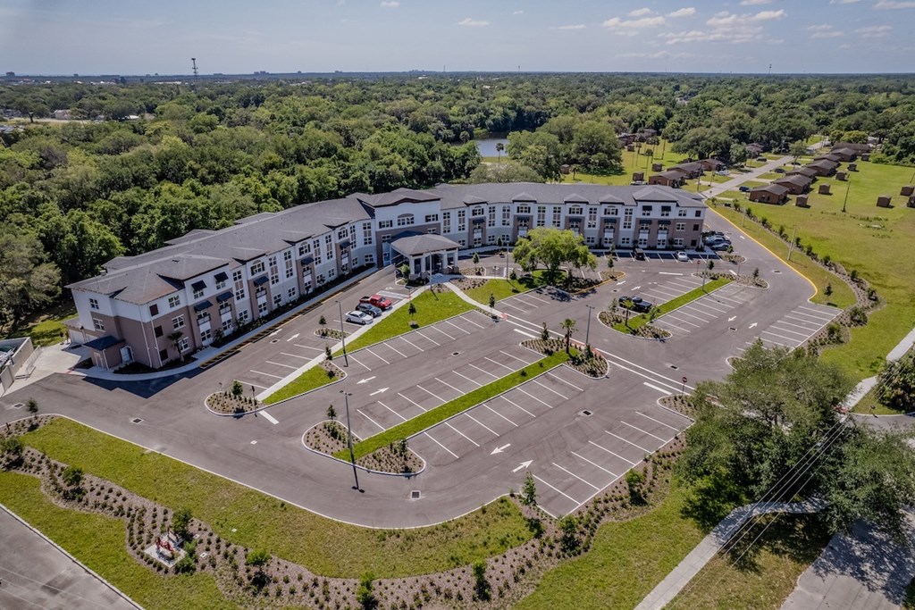 an aerial view of a large parking lot and a large building