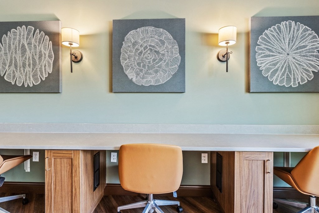 a conference room with chairs and paintings on the wall