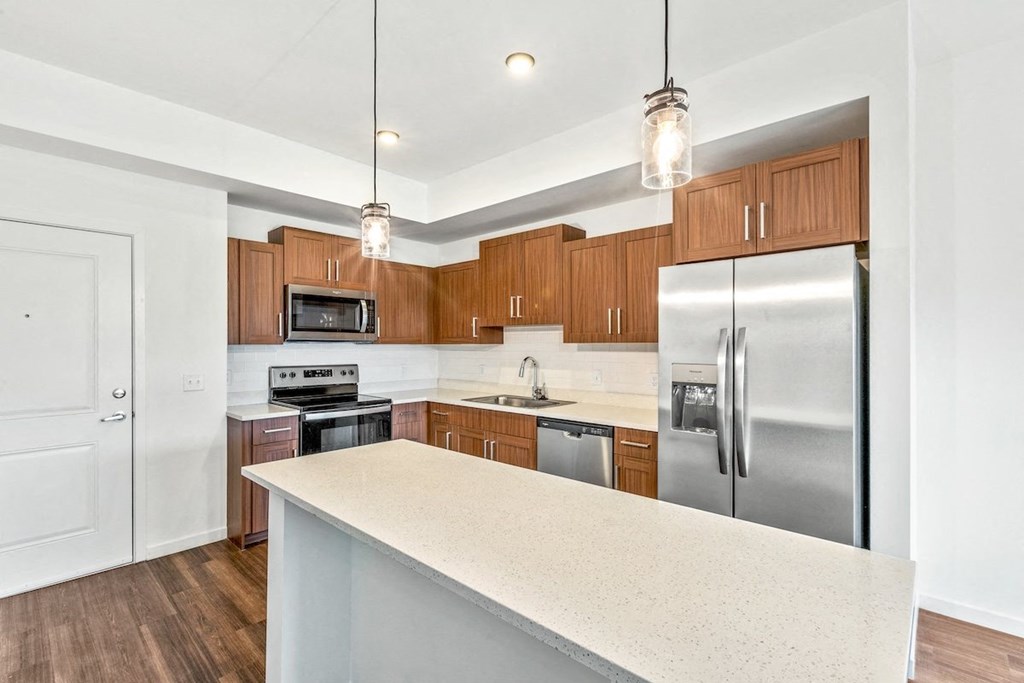 a kitchen with stainless steel appliances and wooden cabinets