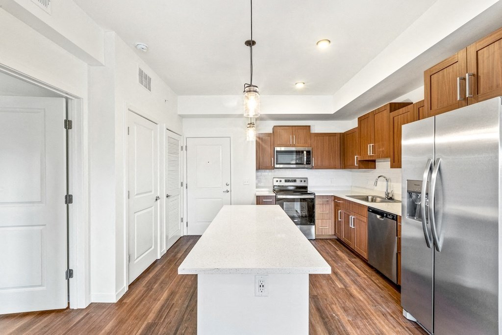 a kitchen with stainless steel appliances and a white counter top
