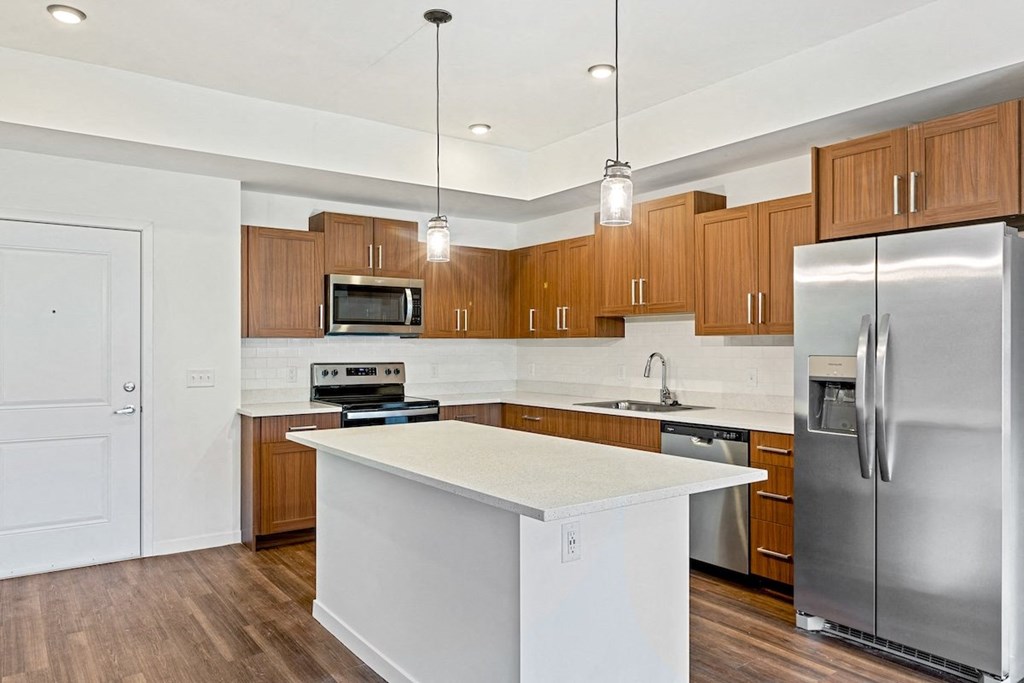 a kitchen with stainless steel appliances and a white counter top