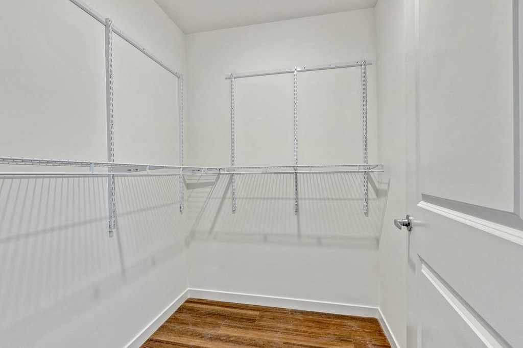 an empty closet in a home with white walls and