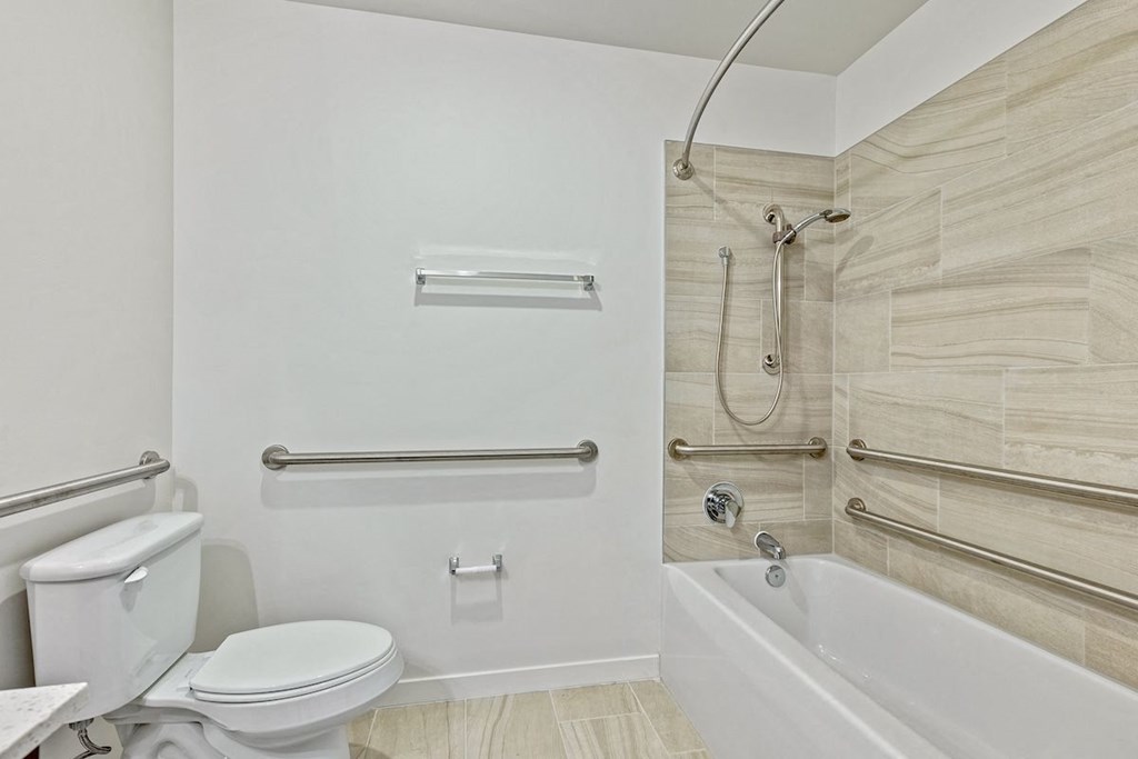 a bathroom with a toilet and a bath tub