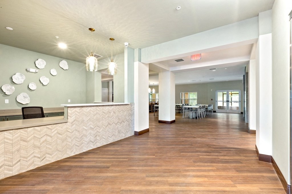 a lobby with a reception desk and a table with chairs