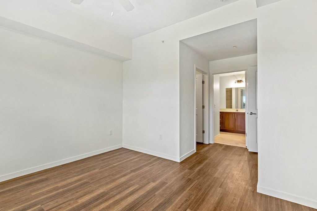 a living room with white walls and wood floors