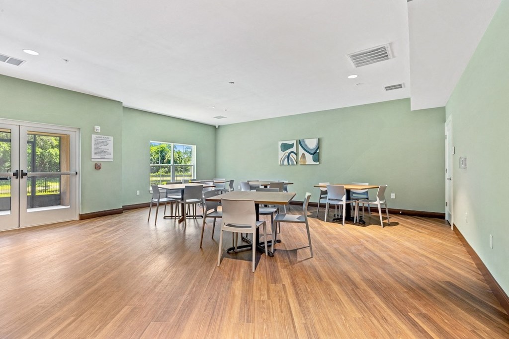 a dining room with tables and chairs and a door