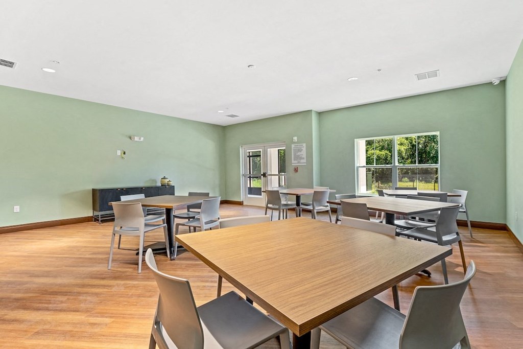 a dining room with tables and chairs and a window
