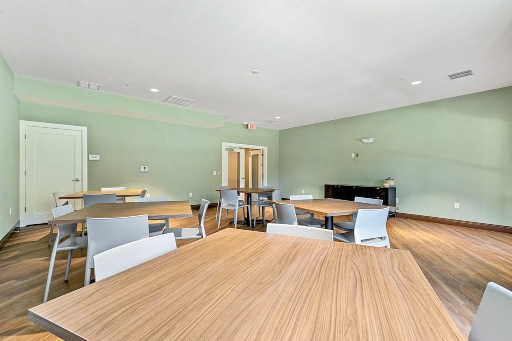 a dining room with tables and chairs and a fireplace