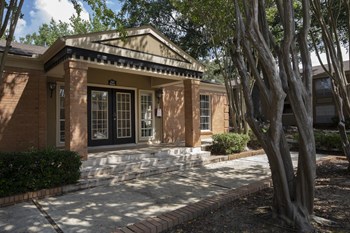 clubhouse with tall crepe myrtles and neat sidewalk at Hampton House - Photo Gallery 10