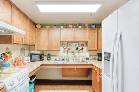 a kitchen with wooden cabinets and a white refrigerator