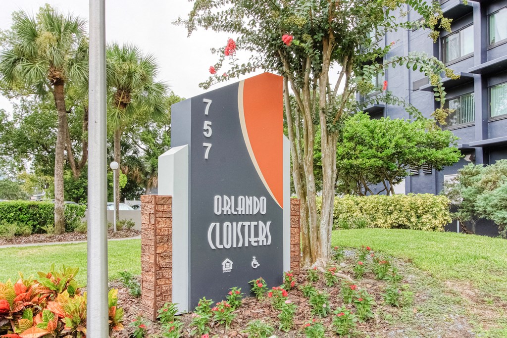 Orlando Cloisters sign in front of senior apartments surrounded by lush landscaping