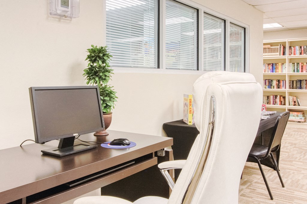 computer station with desk chair near library