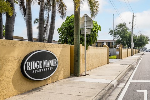 a sign on a wall on the side of a street