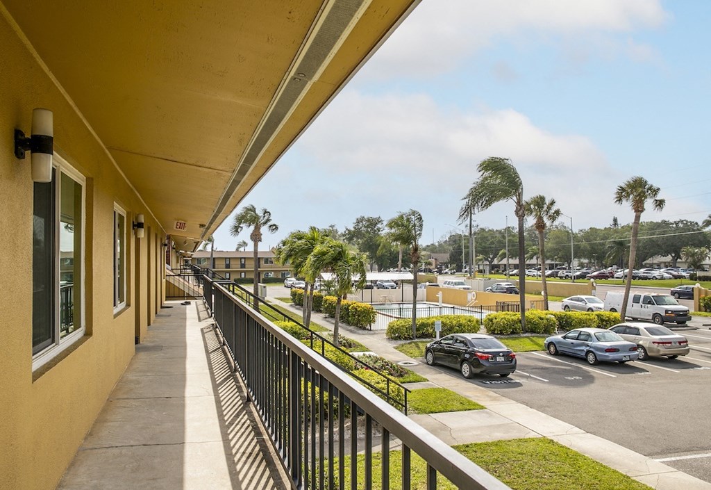 the view of the parking lot from the balcony of a apartment building