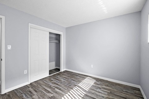an empty room with a door to a closet