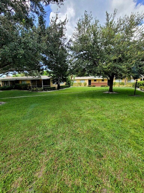 professional landscaping with mature trees and neat lawn