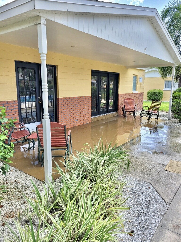 front porch with chairs on a rainy day
